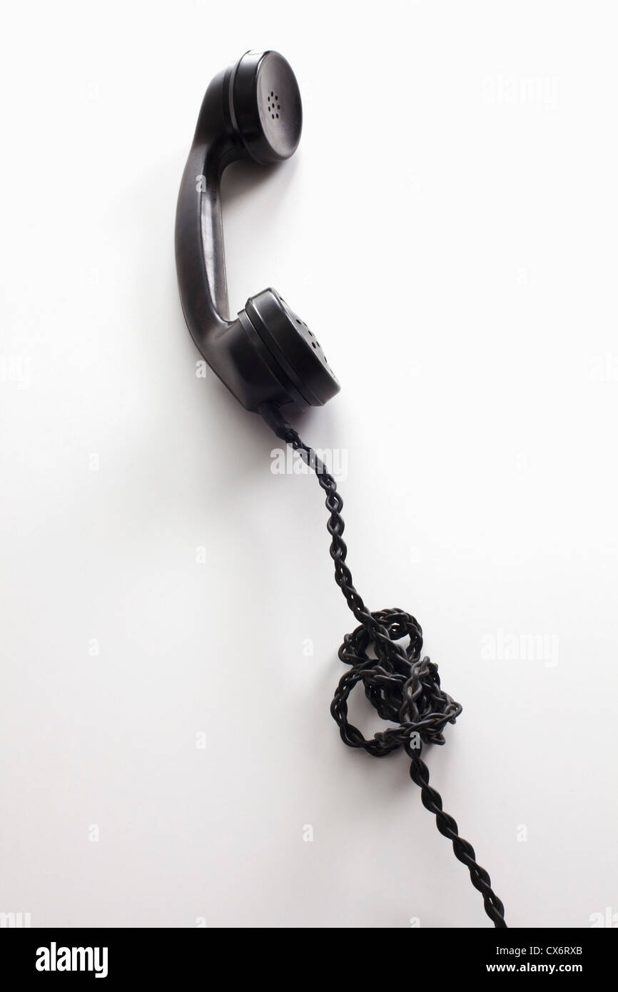 An old-fashioned telephone cord tangled in a knot Stock Photo