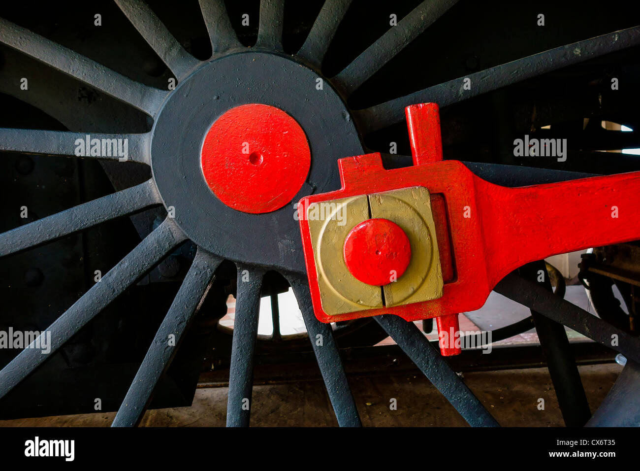 Close up detail of an 1800's steam locomotive's black wheel with red hub and connecting rod in Asunción, Paraguay. Stock Photo