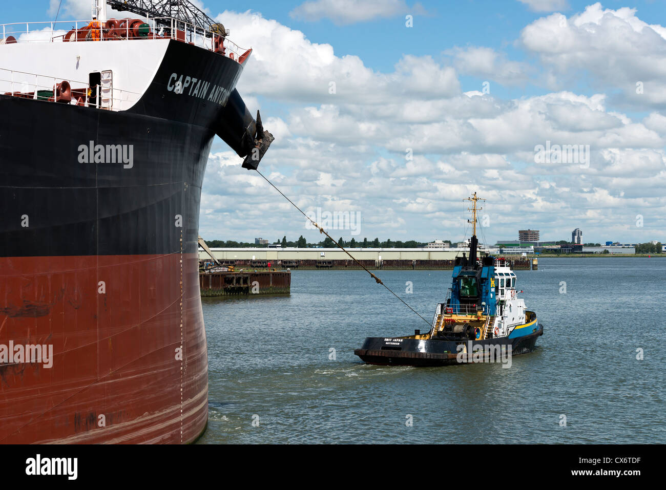 tugboat towing large ship Stock Photo