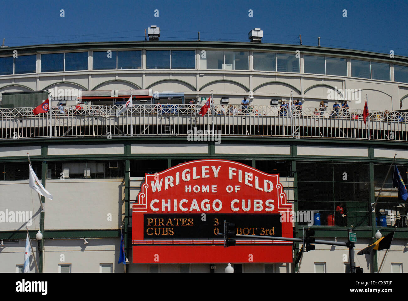 SPORTS Chicago Illinois Night game at Wrigley Field fans in bleachers  traditional scoreboard ivy on outfield wall Stock Photo - Alamy