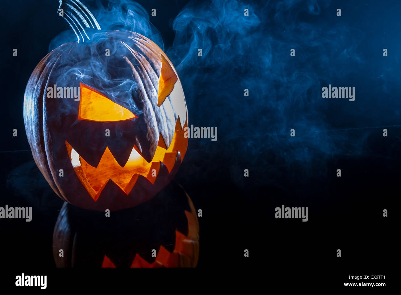 Smoking scary Halloween pumpkin head Stock Photo - Alamy