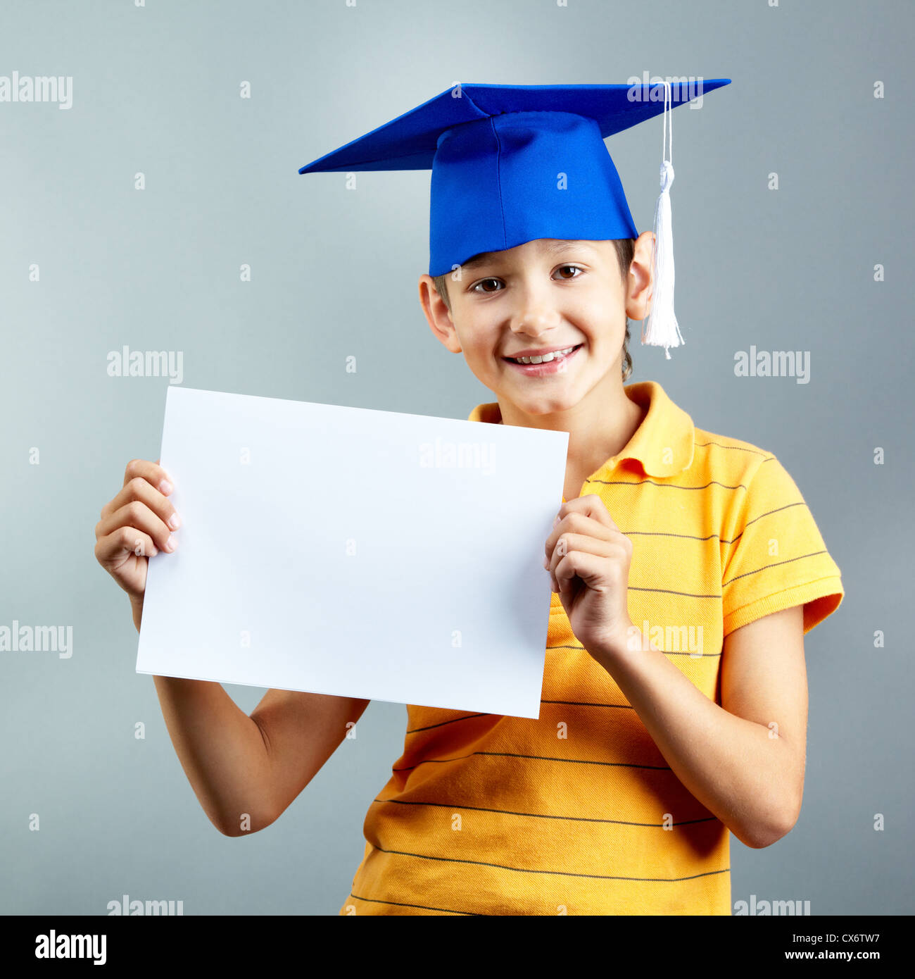 Portrait of happy boy with blank paper looking at camera Stock Photo ...