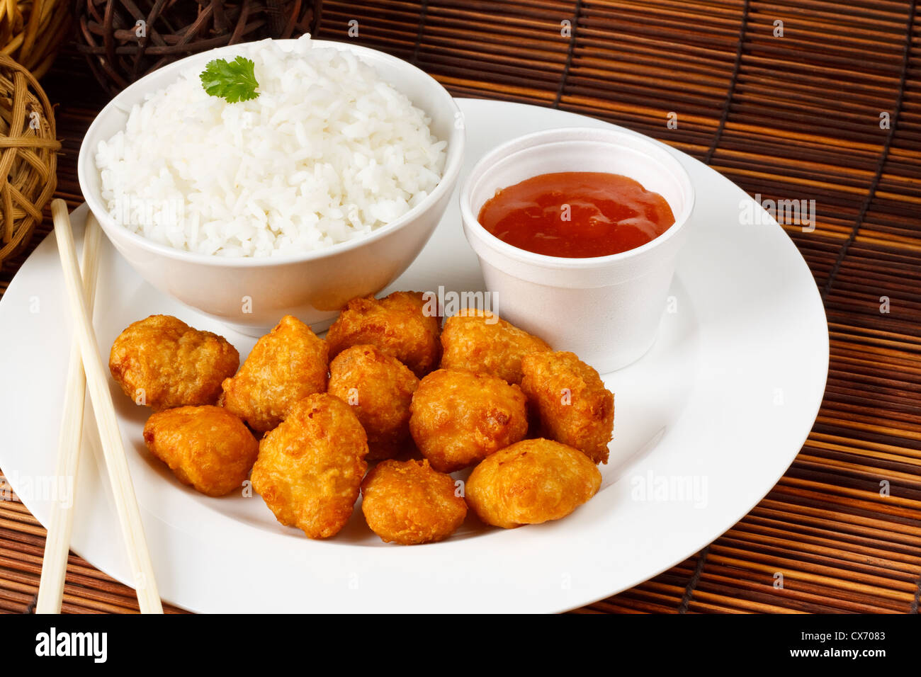 Sweet and sour battered pork balls with boiled rice Stock Photo