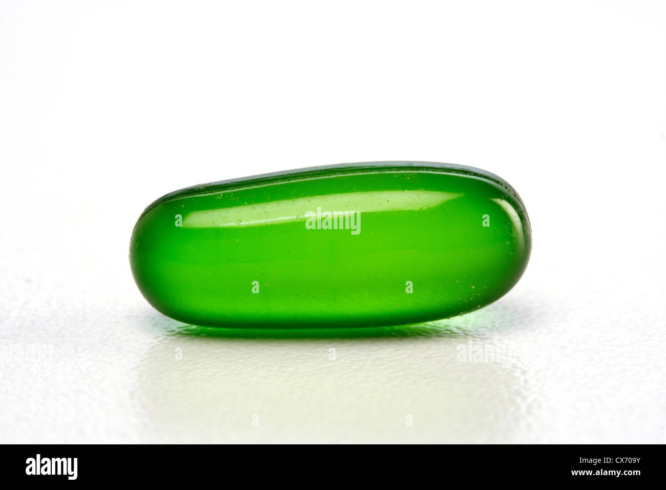 Green gel pill isolated on white background Stock Photo - Alamy