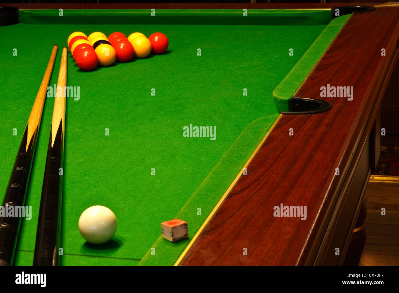 A green cloth billiards or pool table with english league red and yellow balls Stock Photo
