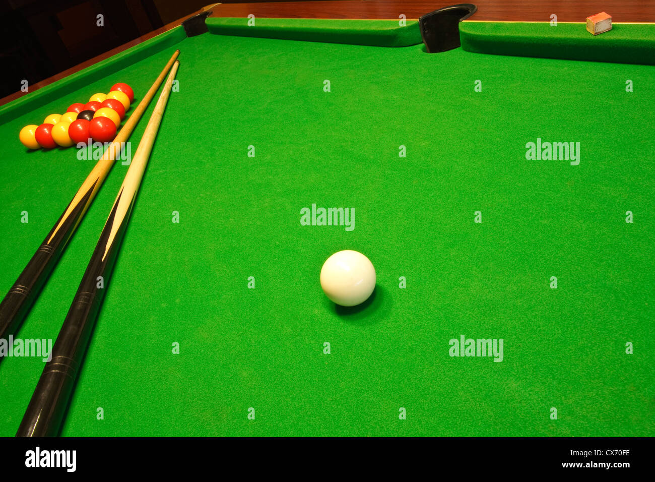 A green cloth billiards or pool table with english league red and yellow balls Stock Photo