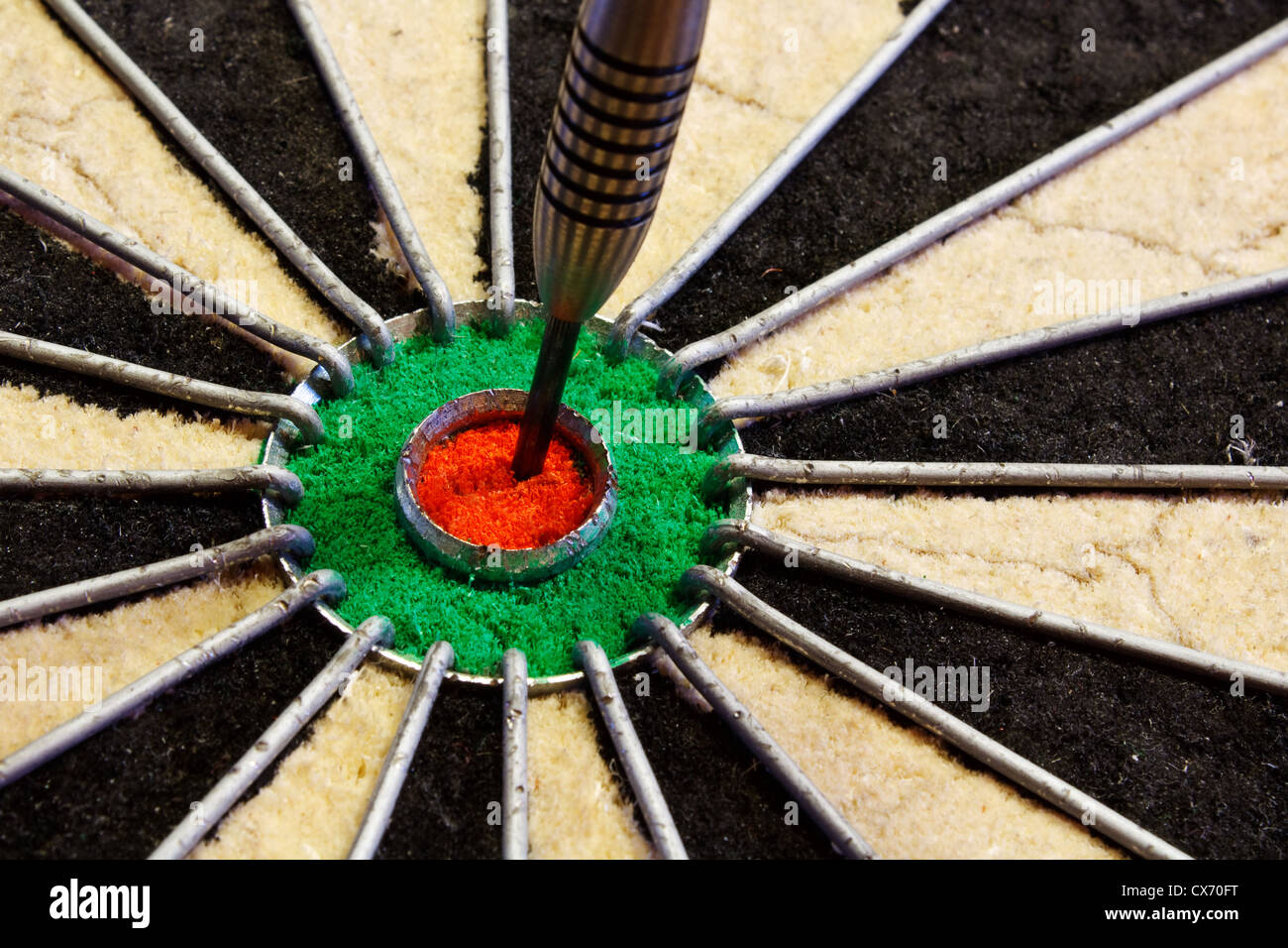 a dart hits target in the centre of a darts board good business concept for success Stock Photo