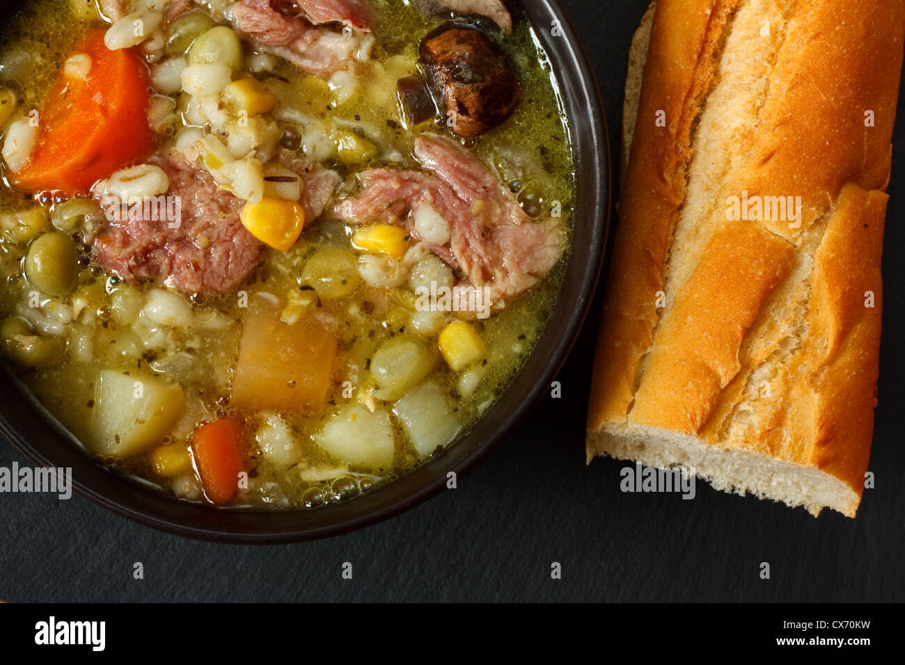 Bowl of ham stew with crusty bread Stock Photo