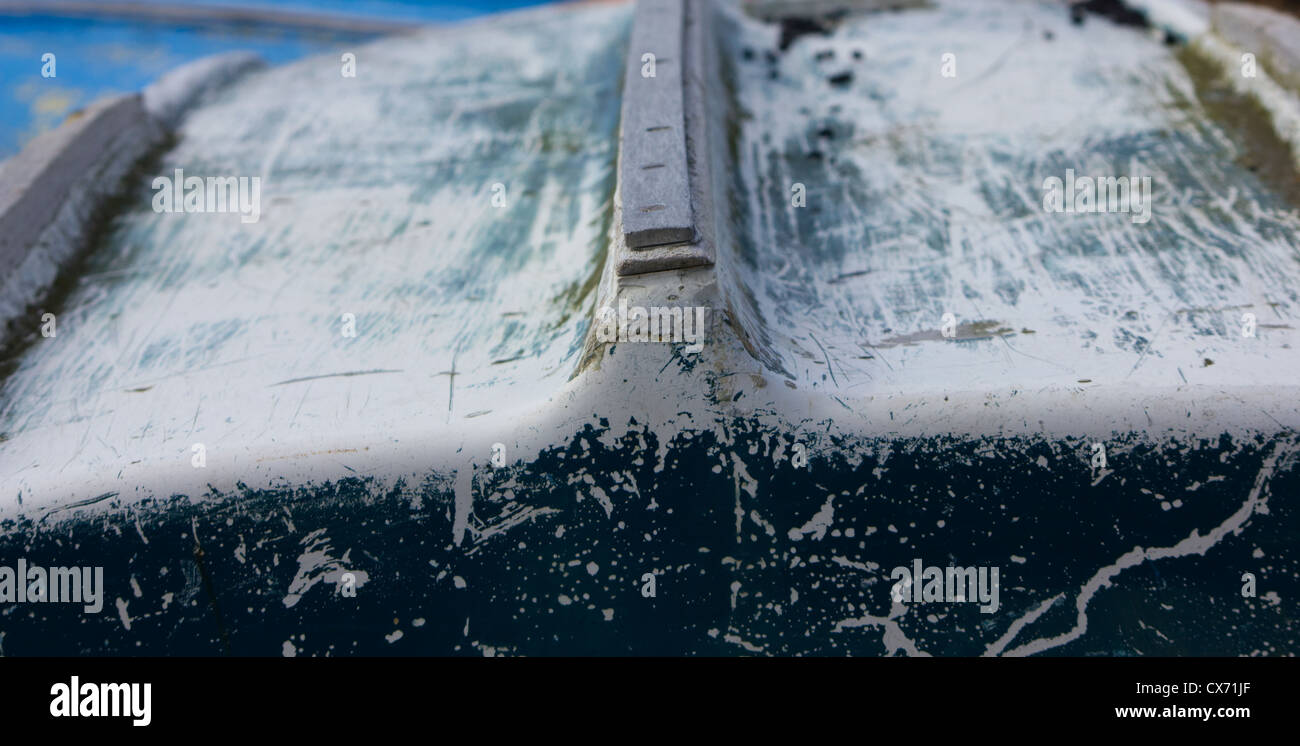 Faded and slightly damaged hull of an upturned rowing boat Stock Photo