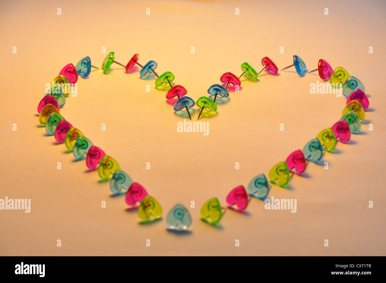 Heart of Hearts - Heart symbol made of coloured plastic heart shaped pins. Stock Photo