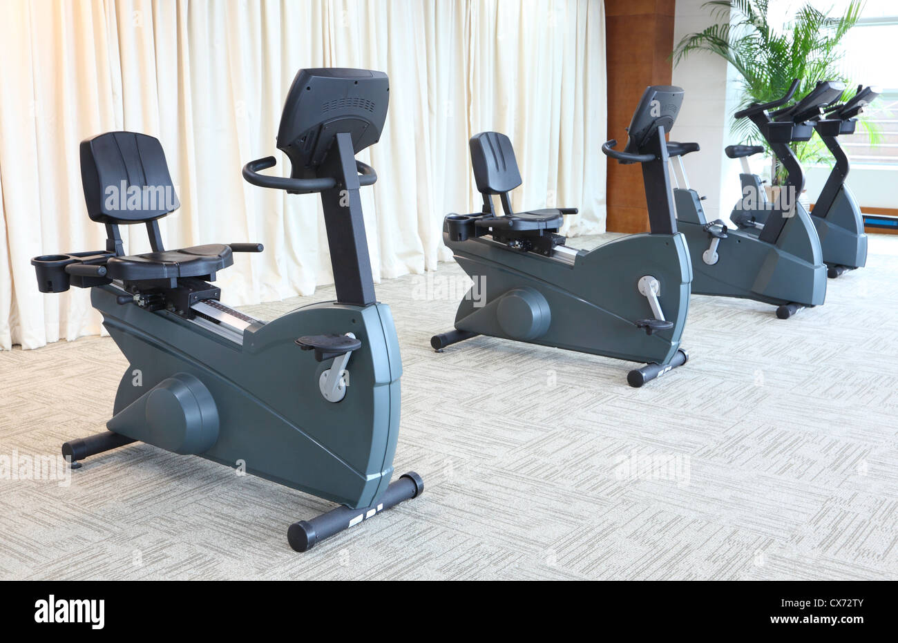 Stationary bikes in gym Stock Photo