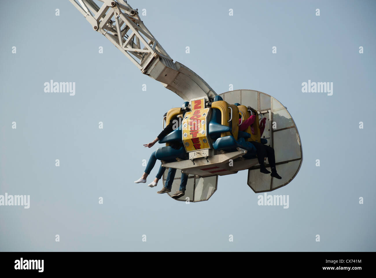 People hanging in The Booster thrill ride at Brighton Pier Stock Photo ...