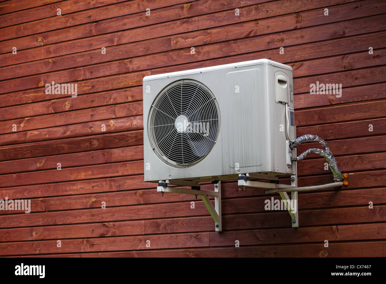 Air conditioner on the wall of boards. Stock Photo