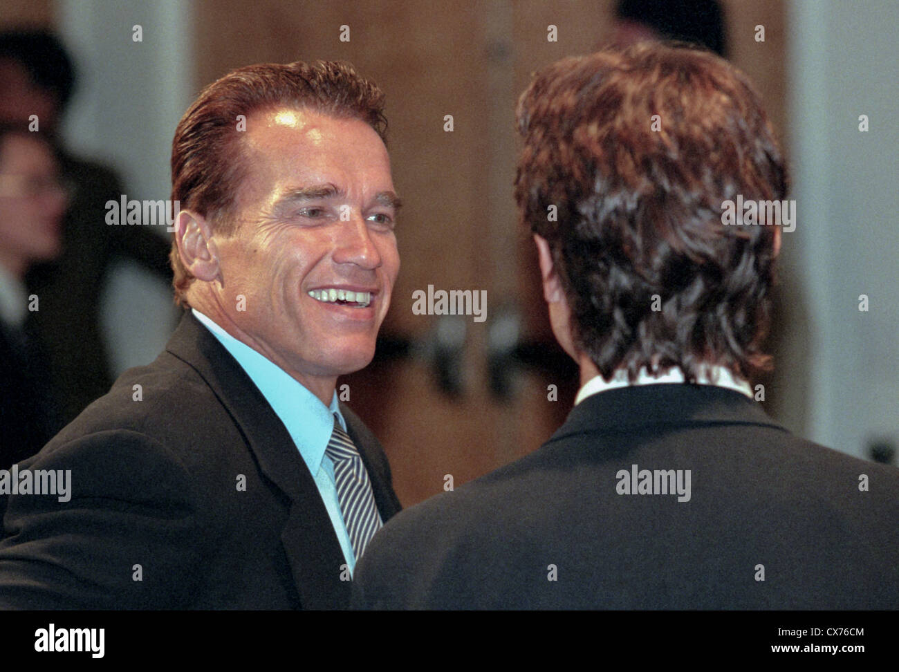 Arnold Schwarzenegger talks with Mark Shriver at the dedication of the new Peace Corps headquarters September 15, 1998 in Washington, DC. Stock Photo