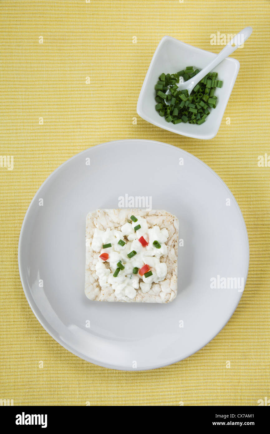 Rice Cake topped with Cottage Cheese and chopped Chives Stock Photo