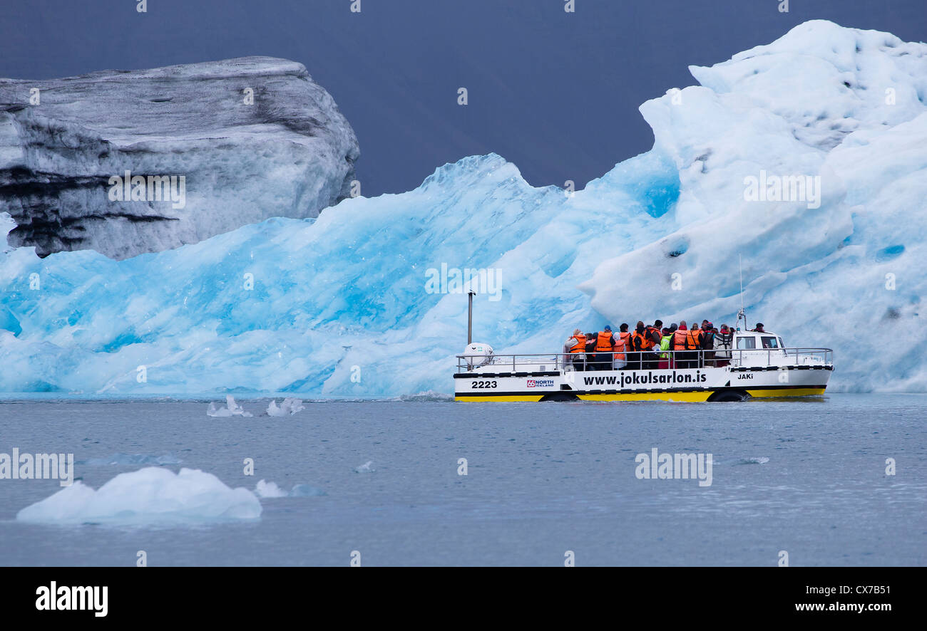 Amphibious vehicle on a tour, sailing past iceburgs, in the jokulsarlon glacial lagoon, Iceland Stock Photo