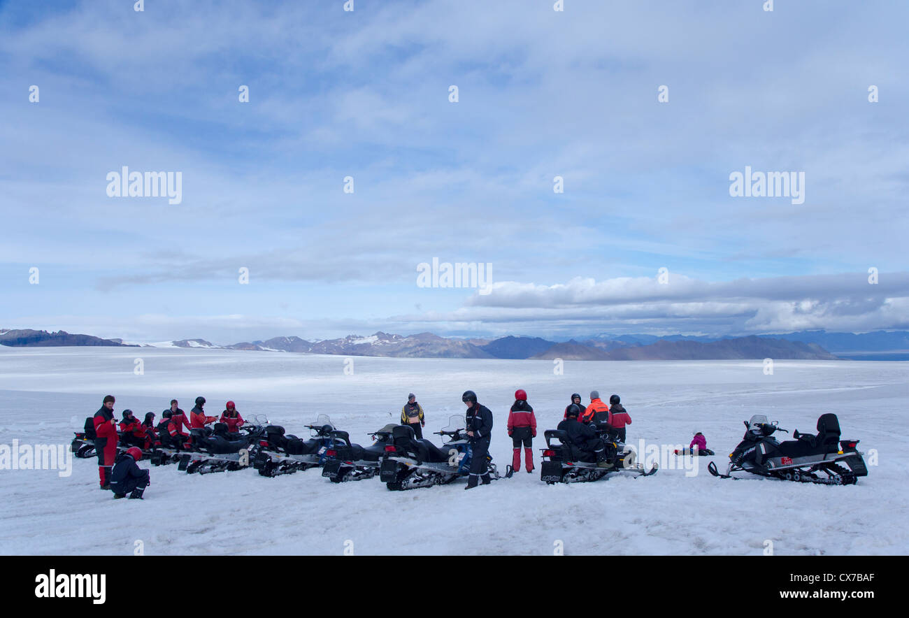 Snow mobiles (skidoos) on the Vatnajökull Glacier, Iceland, on a glacial tour. Stock Photo