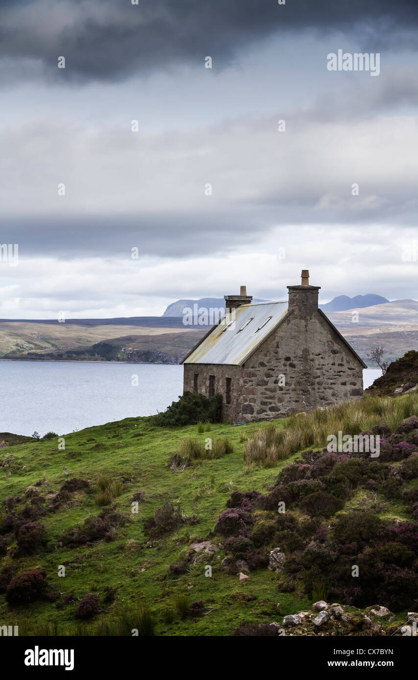 Crofters cottage under stormy skies overlooking Loch Torridon Wester Ross Western Highlands Scotland Stock Photo