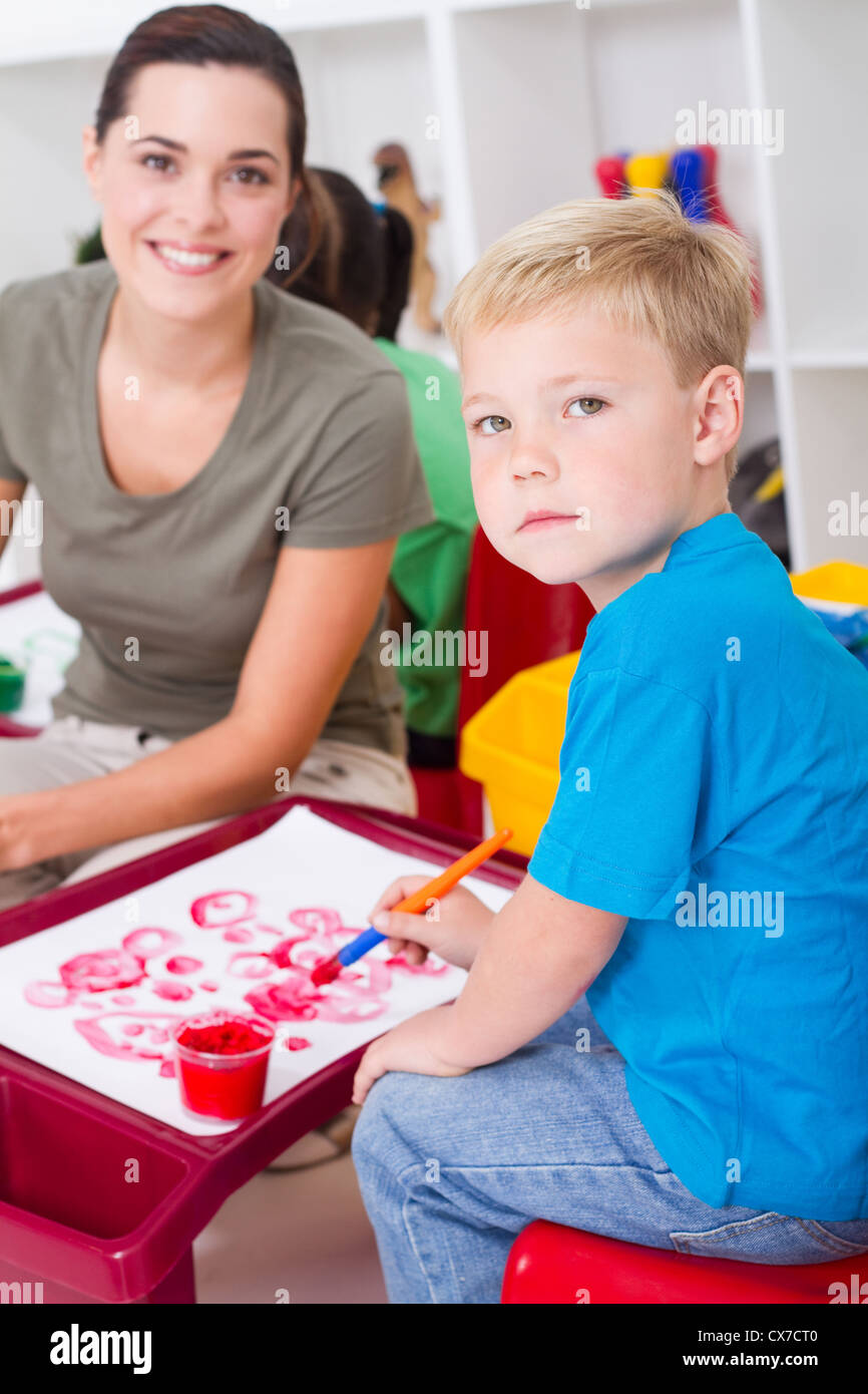 preschool boy and teacher in classroom Stock Photo