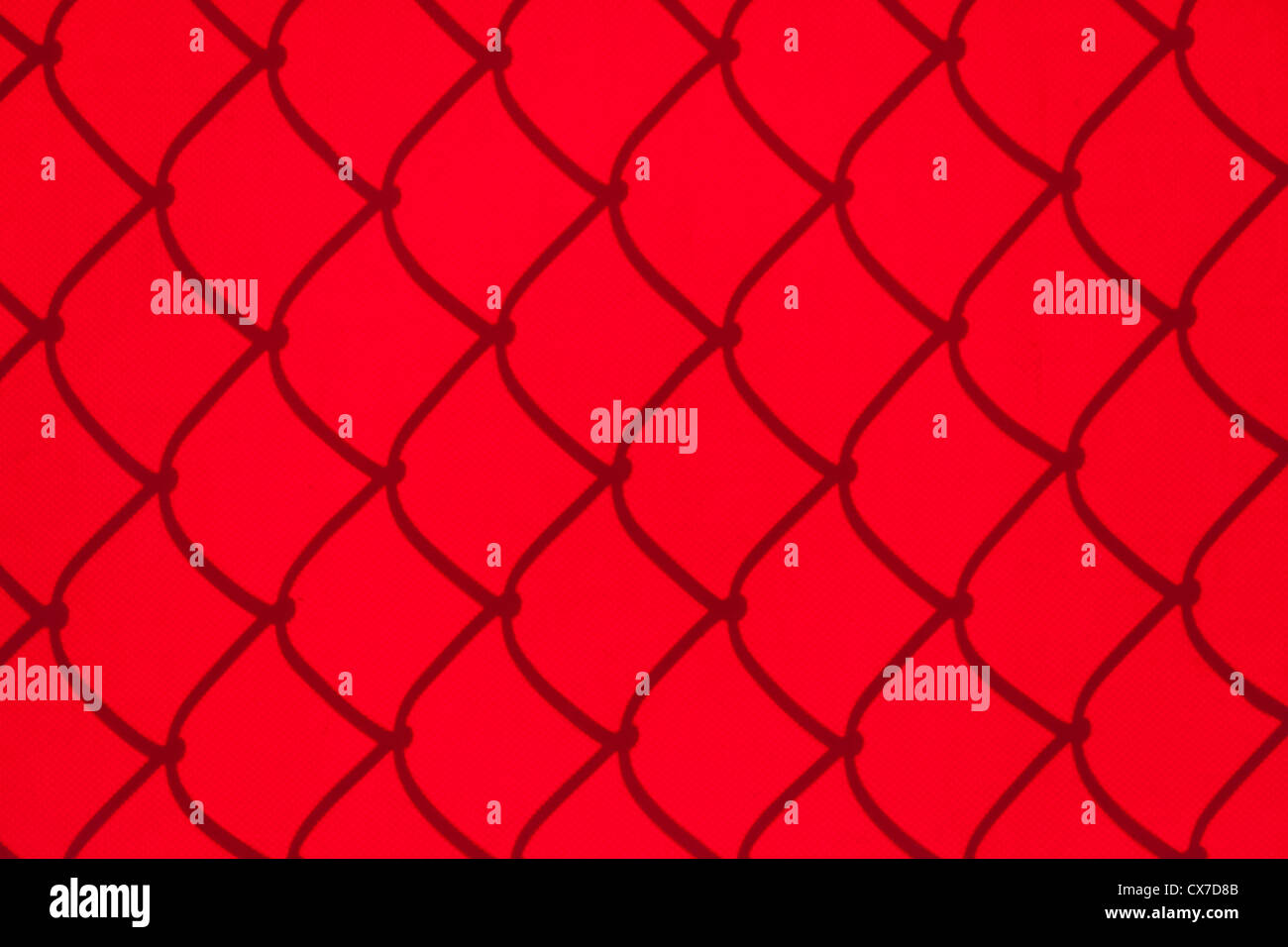 Chainlink Fence Shadow on red Shade Cloth Stock Photo
