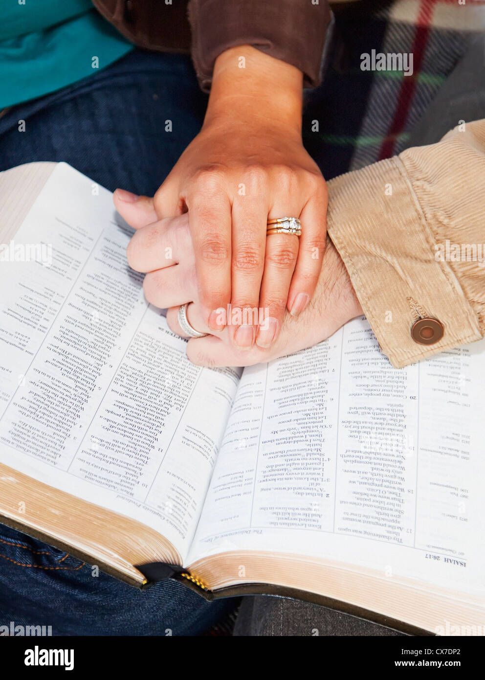 Couples Hands On Top Of A Bible; Edmonton, Alberta, Canada Stock Photo