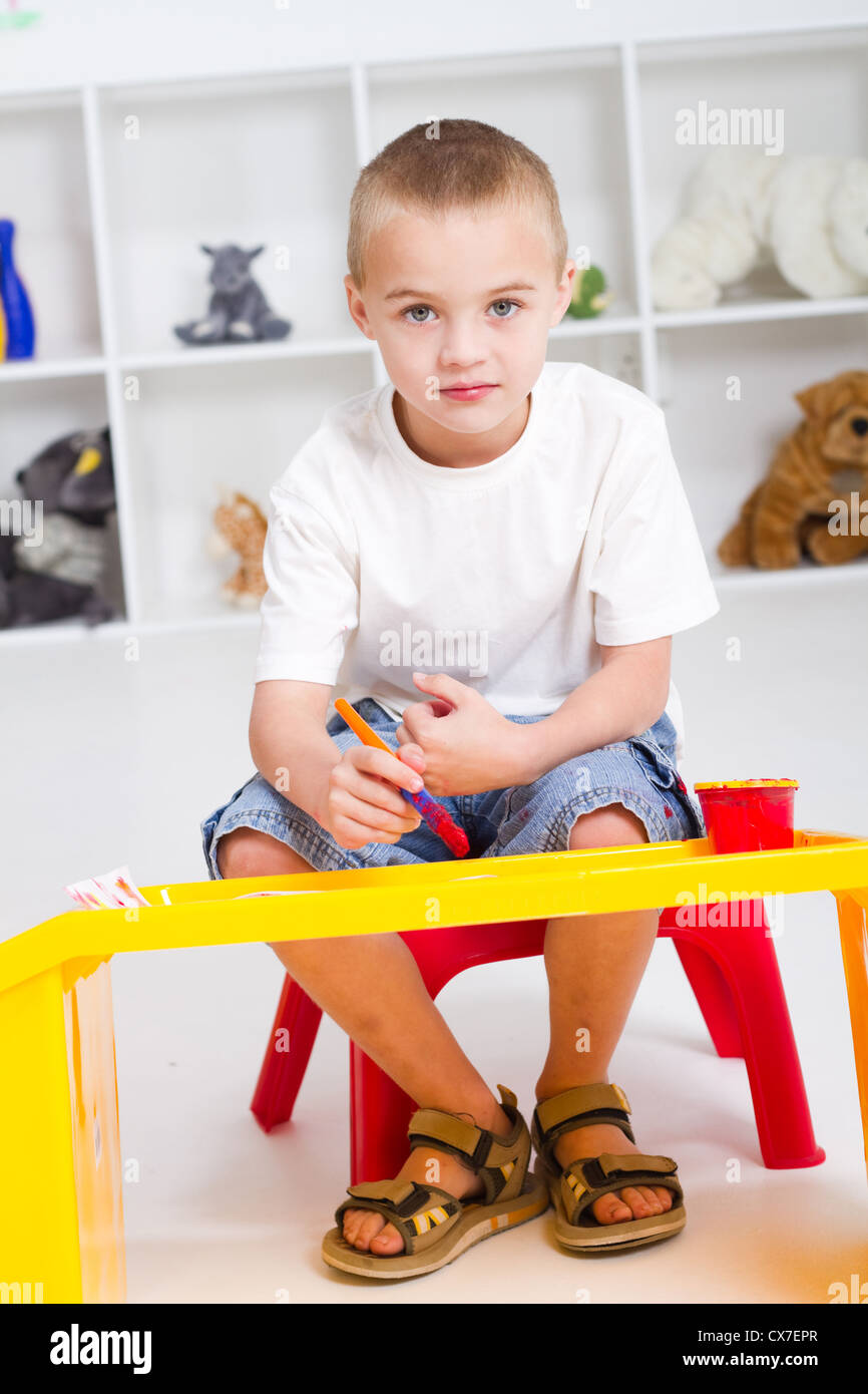 preschool boy paint in classroom Stock Photo