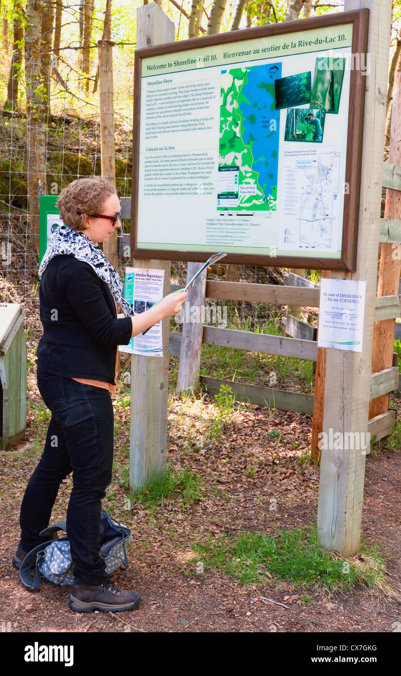 Navigating The Map In Elk Island National Park; Alberta, Canada Stock Photo