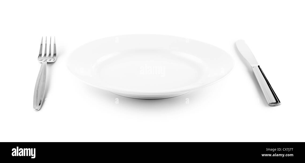 white plate, knife and fork cutlery isolated with clipping paths included Stock Photo