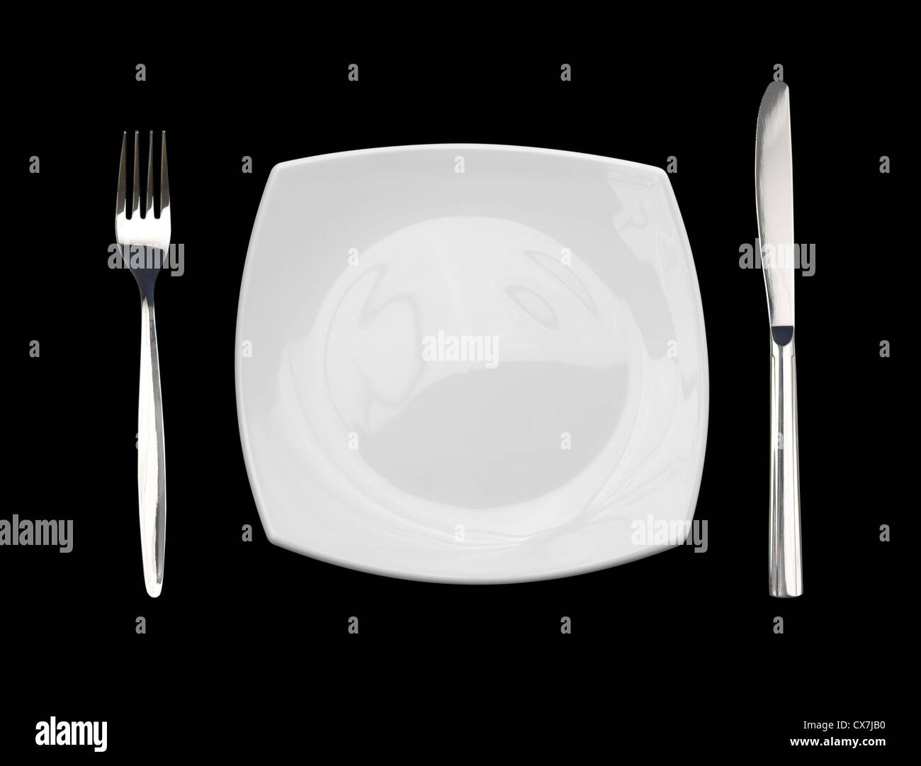 Plate, knife and fork isolated on black Stock Photo