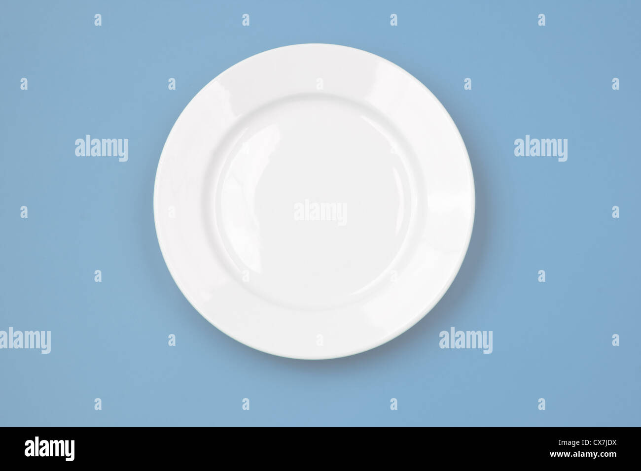 White round plate on sky blue background Stock Photo