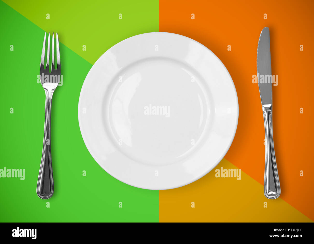 Knife, plate and fork on colorful background Stock Photo