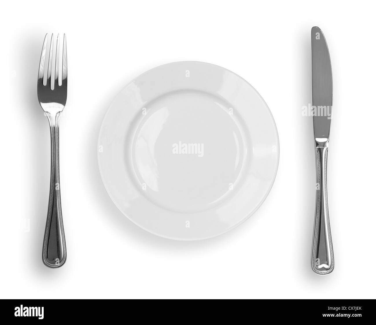 Knife, white plate and fork isolated Stock Photo