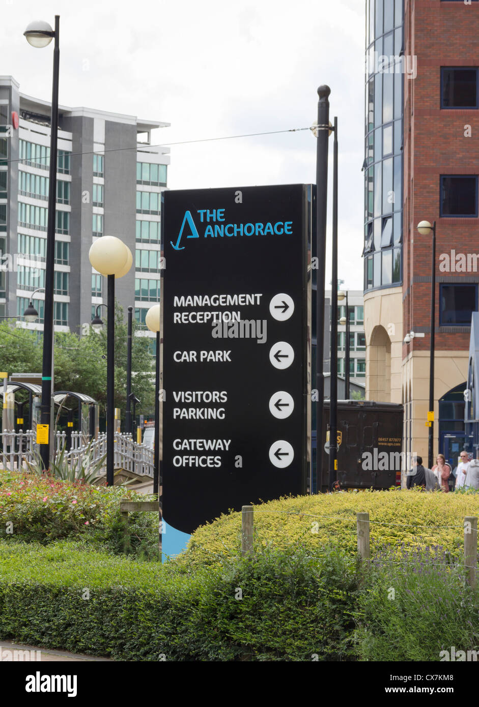 Entrance sign for 'The Anchorage' newly developed office complex on Salford Quays with the Metrolink station behind. Stock Photo