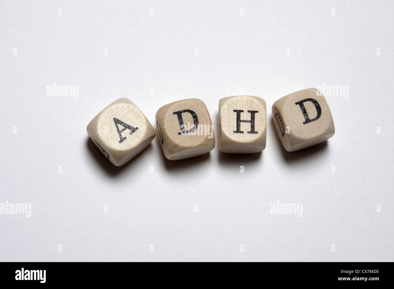 Lettered cubes arranged to spell the abbreviation ADHD Stock Photo