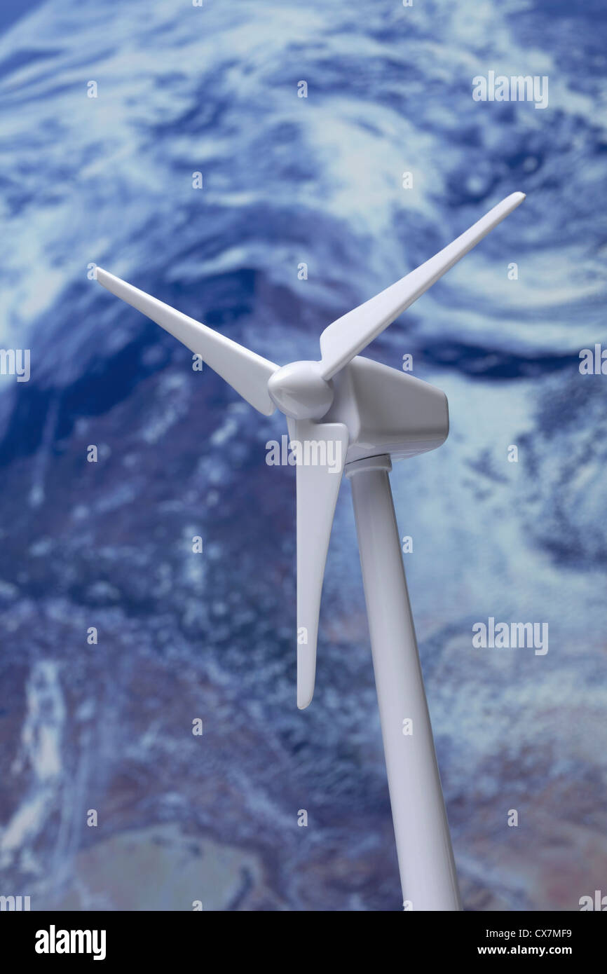 A model of a wind turbine, planet earth in the background Stock Photo