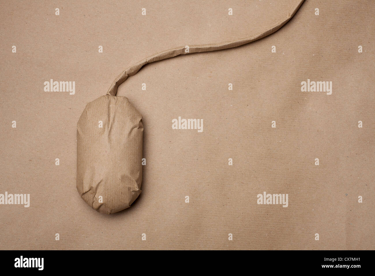 A computer mouse wrapped in brown paper Stock Photo