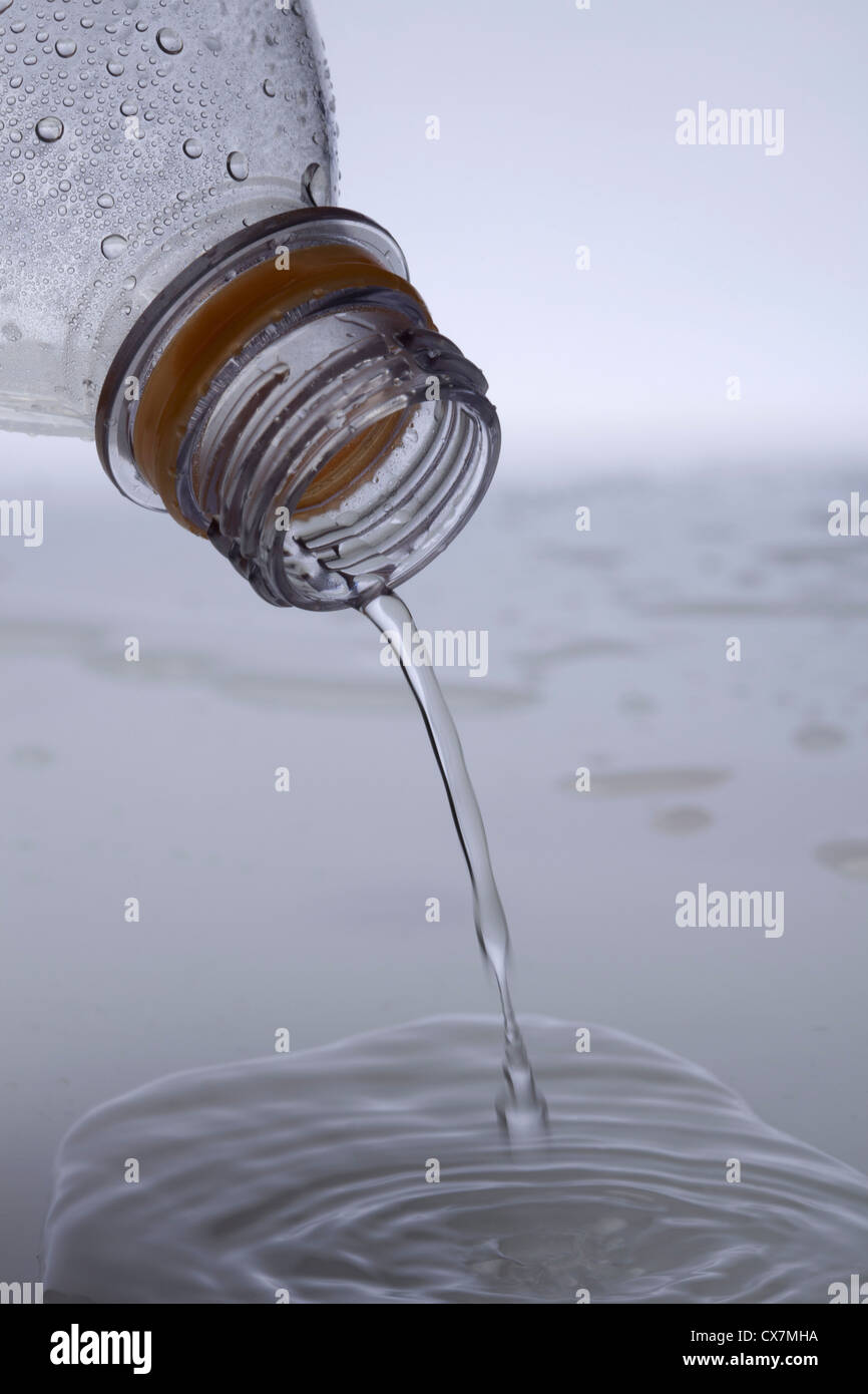 Water pouring out of a plastic water bottle, close-up Stock Photo