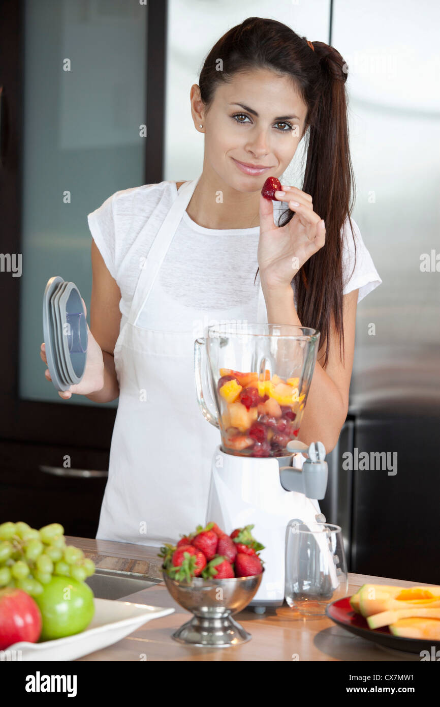 Woman with fruit blender Stock Photo
