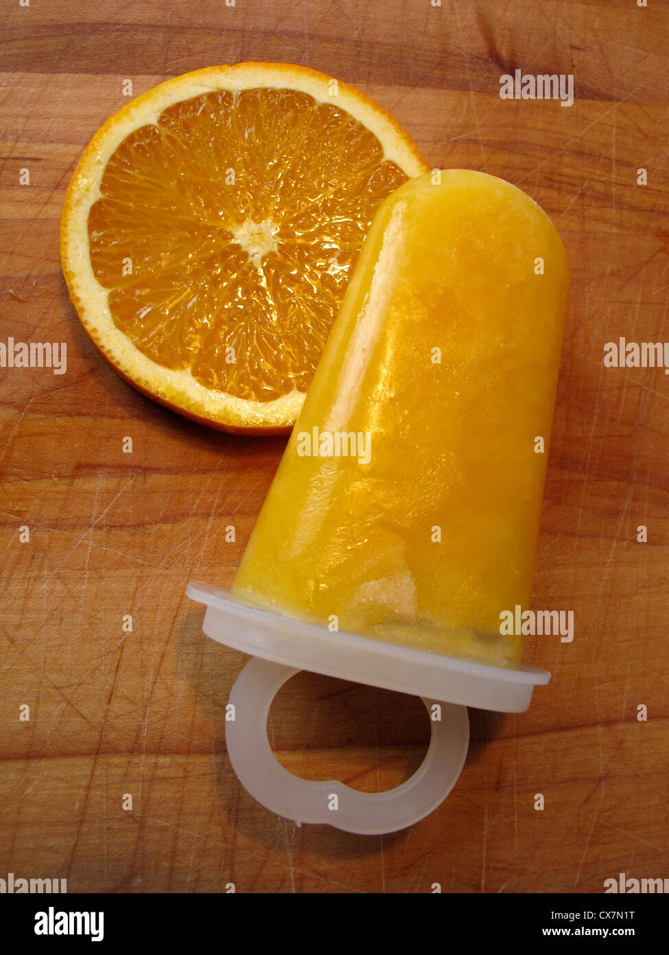 Homemade ice pop and slice of orange Stock Photo