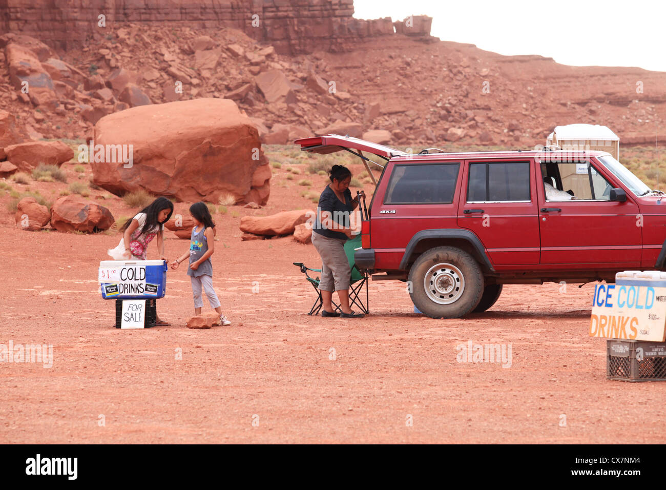 Native Navajo Indian family packing up trading goods advent approaching thunderstorm in Monument valley, Arizona, US Stock Photo