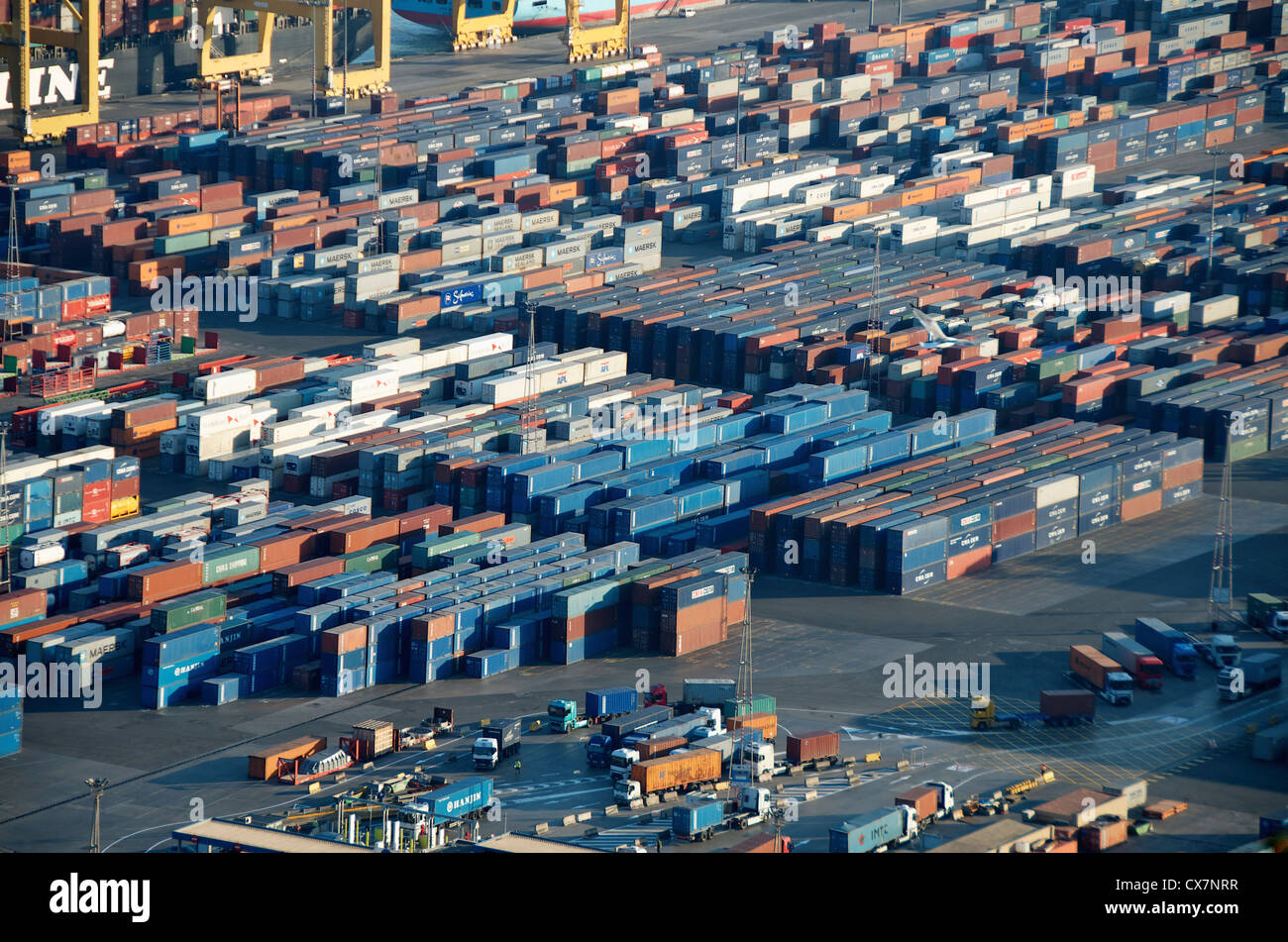 Lorries loading cargo containers at the docks in Barcelona, Spain Stock
