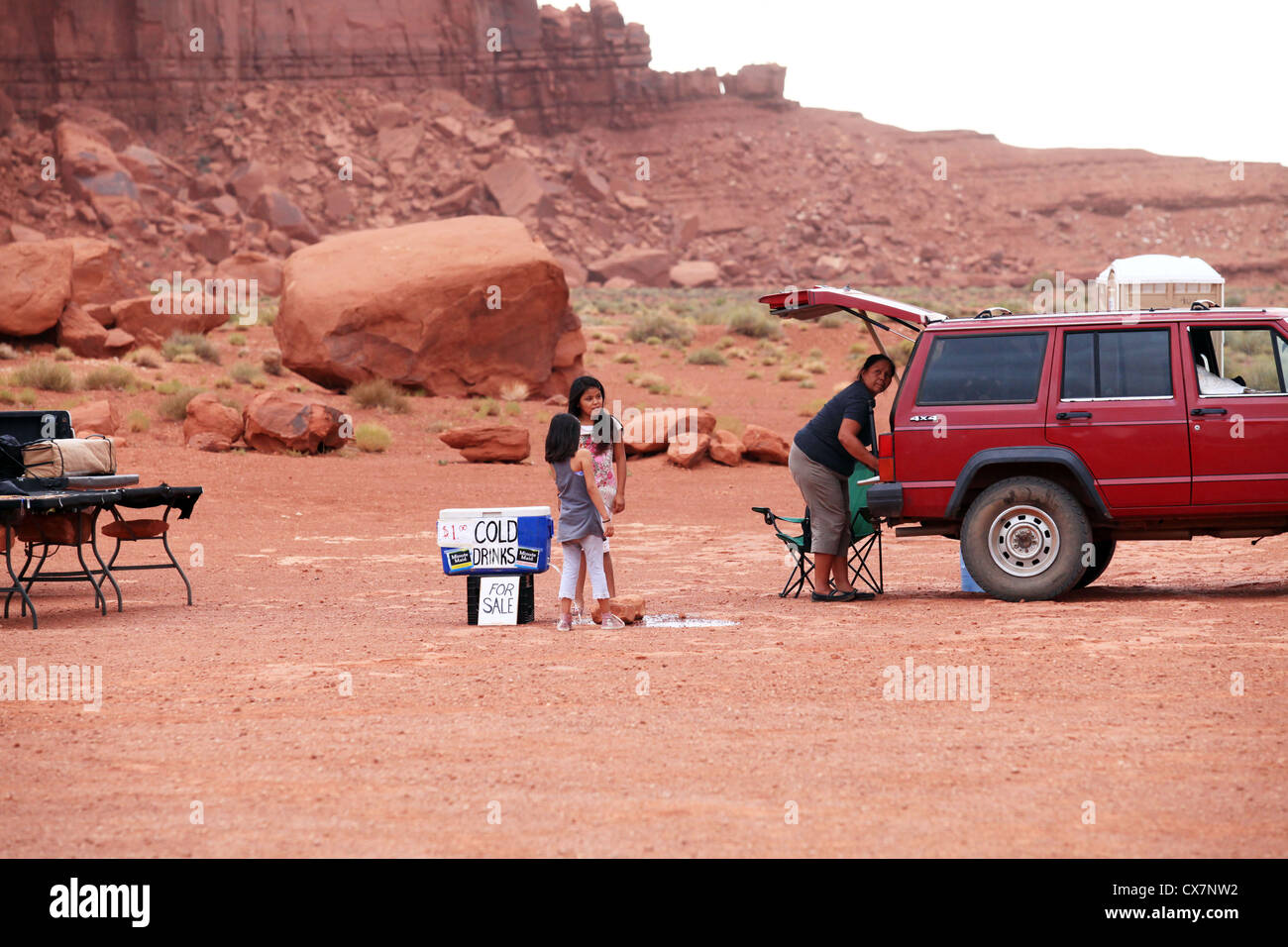 Native Navajo Indian family packing up trading goods advent approaching thunderstorm in Monument valley, Arizona, US Stock Photo