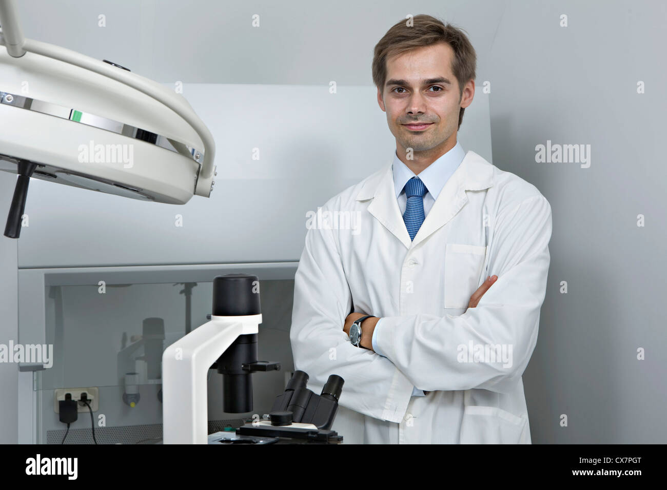 A smiling research technician standing in a research lab Stock Photo