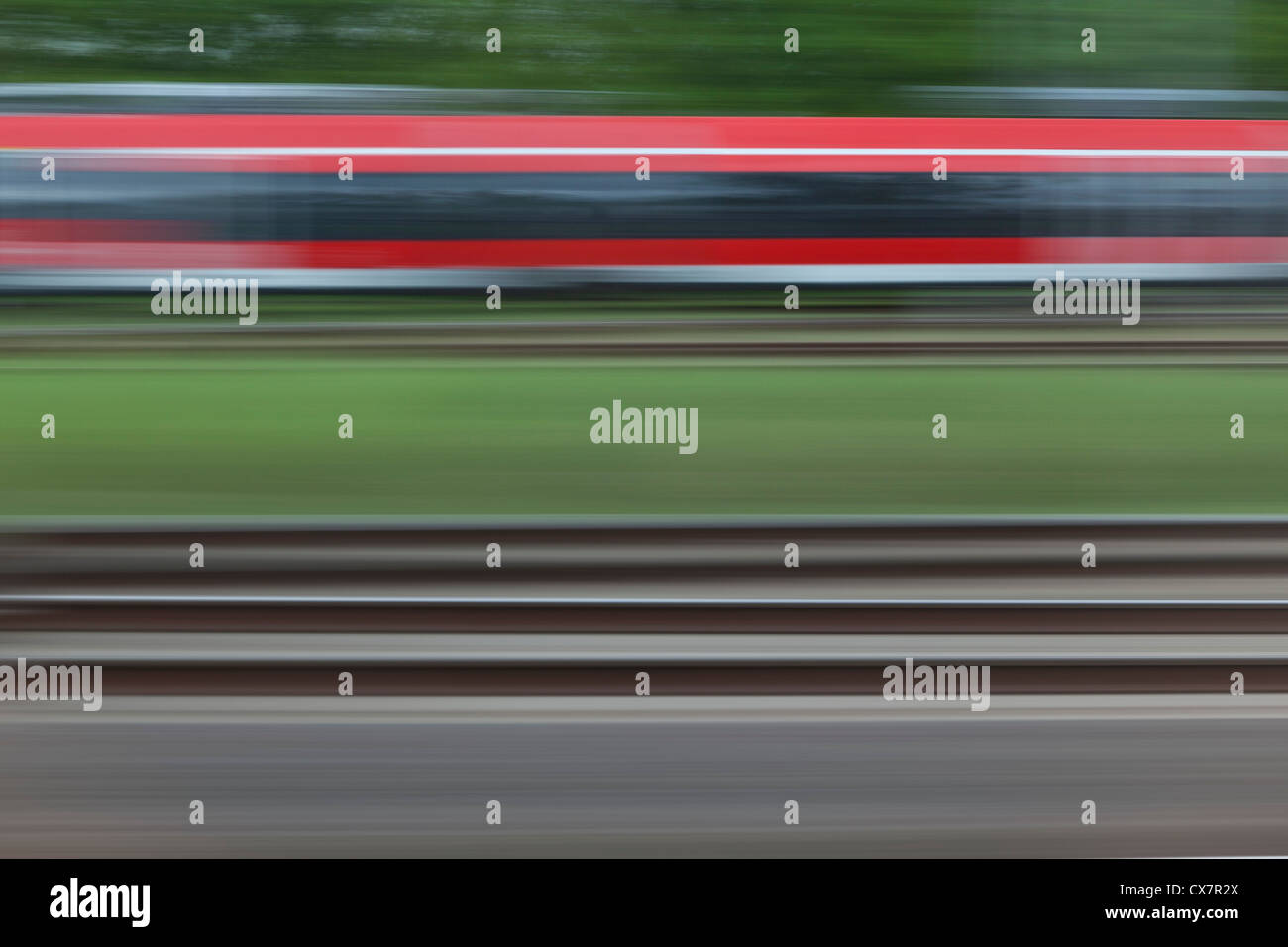 Railroad tracks and a train, blurred motion, viewed from a moving train Stock Photo