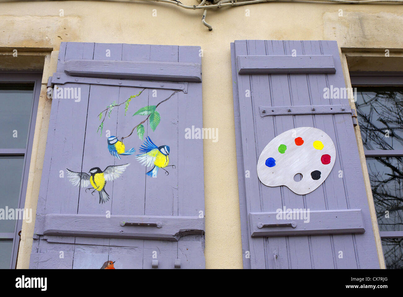 Songbirds painted on the shutters of an artist's studio in Fort Brouage, France. Stock Photo