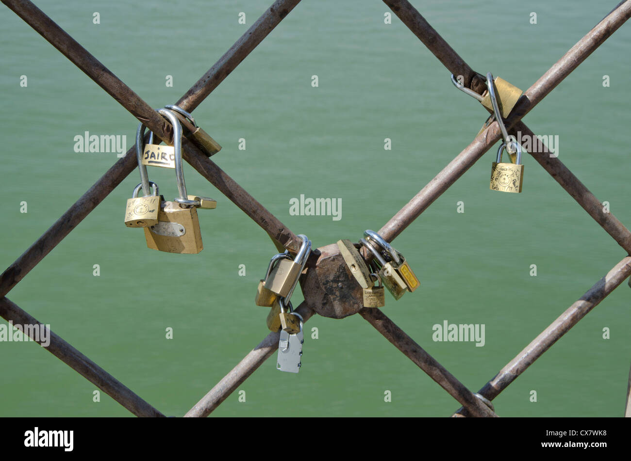 Love locks or padlocks on a bridge in Seville, Spain. Stock Photo