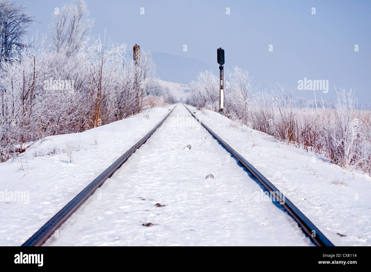 Railroad track in winter, frozen landscape, infinite direction Stock Photo