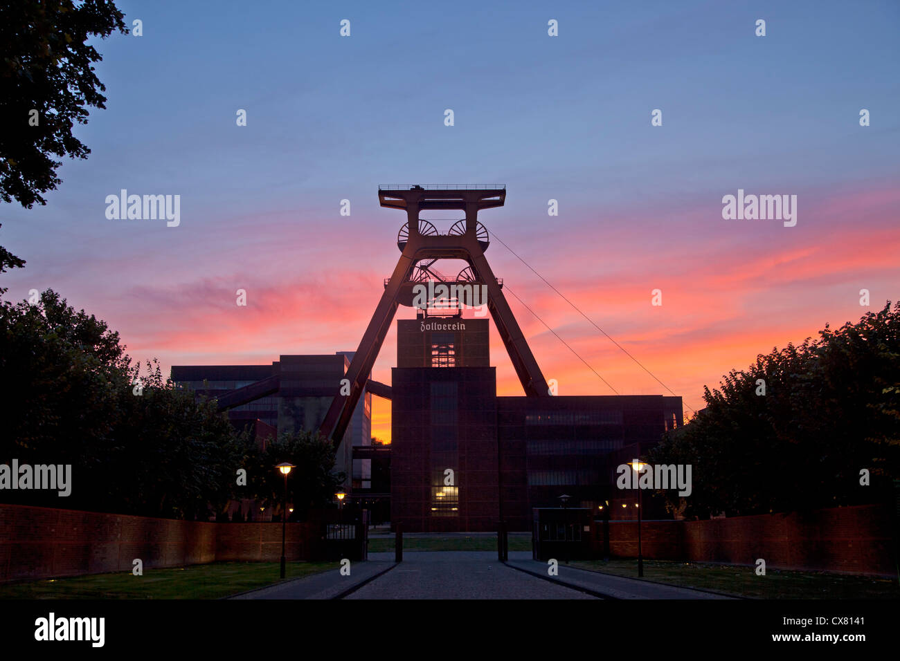colourful sunset at the winding tower of shaft 12 at Zollverein Coal Mine Industrial Complex in Essen, Germany Stock Photo
