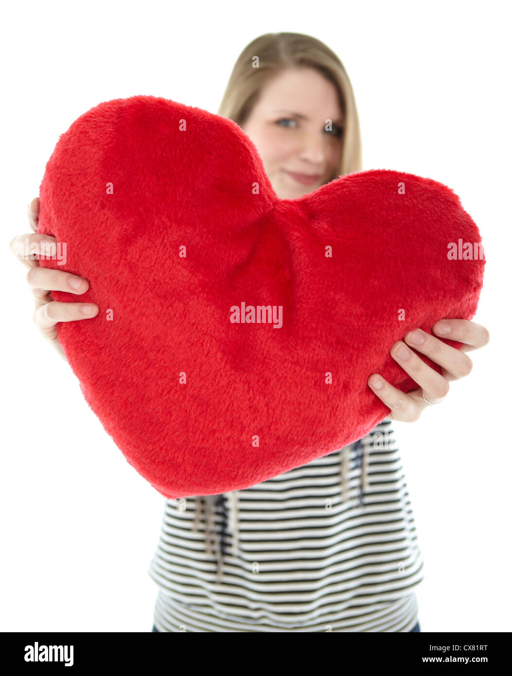 Woman with heart pillow Stock Photo
