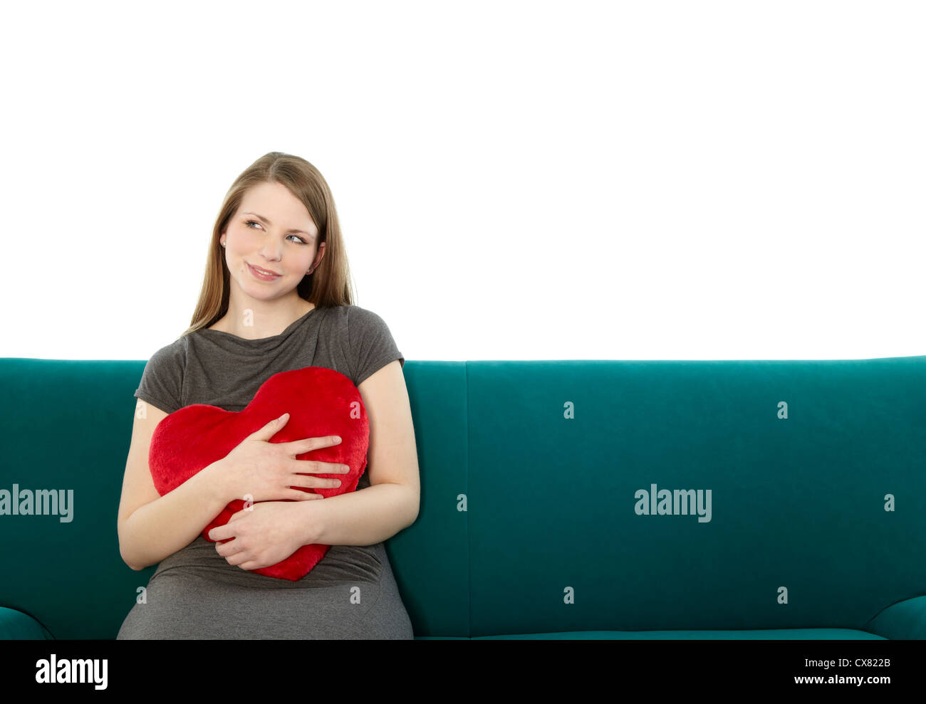 Woman with heart pillow Stock Photo